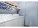Laundry room featuring a washer and dryer with a storage shelf and door to the exterior at 610 S St Paul --, Mesa, AZ 85206