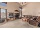 Inviting living room featuring a brick fireplace, vaulted ceiling, large windows, and comfortable seating at 610 S St Paul --, Mesa, AZ 85206