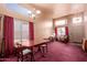 Spacious living room with tall windows providing great light, red drapes, carpet and ample seating at 610 S St Paul --, Mesa, AZ 85206