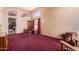 Expansive living room featuring vaulted ceiling, large windows, neutral walls and carpeting, and a doorway at 610 S St Paul --, Mesa, AZ 85206