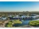 Stunning aerial view of modern homes overlooking a golf course and a tranquil lake at 6142 E Alta Hacienda Dr, Scottsdale, AZ 85251