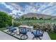 Scenic backyard featuring a modern fire pit seating area with mountain and golf course views for relaxing outdoor living at 6142 E Alta Hacienda Dr, Scottsdale, AZ 85251