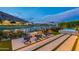 Backyard fire pit and hot tub with golf course and lake views create relaxing outdoor living space with a mountain backdrop at 6142 E Alta Hacienda Dr, Scottsdale, AZ 85251