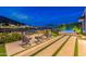 Backyard fire pit and hot tub with golf course and lake views create a relaxing outdoor living space at night at 6142 E Alta Hacienda Dr, Scottsdale, AZ 85251
