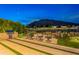 A backyard fire pit with golf course and mountain views makes for a relaxing evening and entertaining outdoors at 6142 E Alta Hacienda Dr, Scottsdale, AZ 85251