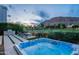 Hot tub, fire pit and grill create a beautiful outdoor living space with manicured landscaping and stunning mountain views at 6142 E Alta Hacienda Dr, Scottsdale, AZ 85251