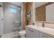 Modern bathroom with a sleek glass shower, stylish vanity, and unique patterned wallpaper at 6142 E Alta Hacienda Dr, Scottsdale, AZ 85251