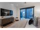 Bedroom features a large tv, access to a balcony, and stylish decor at 6142 E Alta Hacienda Dr, Scottsdale, AZ 85251