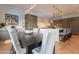 A modern dining area with an open concept layout to the kitchen and it features hardwood floors and contemporary lighting at 6142 E Alta Hacienda Dr, Scottsdale, AZ 85251