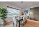An elegant dining area showcases a large window with golf course views and stylish decor in a modern home at 6142 E Alta Hacienda Dr, Scottsdale, AZ 85251