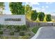 Community entrance sign surrounded by lush greenery and landscaping at 6142 E Alta Hacienda Dr, Scottsdale, AZ 85251