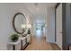 A bright entry hall with hardwood floors, a decorative mirror and console table with a plant and lamps at 6142 E Alta Hacienda Dr, Scottsdale, AZ 85251