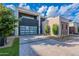 Contemporary home featuring a glass garage door, desert landscaping, and a paved driveway at 6142 E Alta Hacienda Dr, Scottsdale, AZ 85251