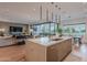 Bright open concept with kitchen island, living and dining spaces under modern lighting at 6142 E Alta Hacienda Dr, Scottsdale, AZ 85251