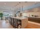 A modern, open-concept kitchen with a large island and dining area, flooded with natural light at 6142 E Alta Hacienda Dr, Scottsdale, AZ 85251