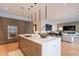 Modern kitchen with large island, custom cabinets, and an open layout to the living area at 6142 E Alta Hacienda Dr, Scottsdale, AZ 85251