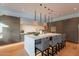 A modern kitchen featuring a large island with seating, sleek countertops, and custom cabinetry at 6142 E Alta Hacienda Dr, Scottsdale, AZ 85251