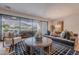 Open living room with hardwood floors, stylish furniture, a large glass door to outdoor space, and mountain views at 6142 E Alta Hacienda Dr, Scottsdale, AZ 85251