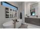 Sleek bathroom features a modern tub and floating cabinets with stylish mirrors at 6142 E Alta Hacienda Dr, Scottsdale, AZ 85251