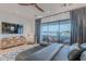 Bright bedroom features a ceiling fan, large windows and access to a balcony at 6142 E Alta Hacienda Dr, Scottsdale, AZ 85251