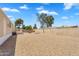 Wide shot of backyard with deck and trampoline in a low maintenance desert landscape at 633 S 96Th St, Mesa, AZ 85208
