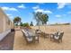 Backyard showcasing an outdoor seating area, gravel landscaping, and a secure wood fence at 633 S 96Th St, Mesa, AZ 85208