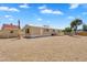 Backyard with rock landscaping and features like a fire pit, trampoline, and shaded patio at 633 S 96Th St, Mesa, AZ 85208