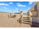 A backyard showcasing a fire pit and a wood deck and stairs leading to the back door at 633 S 96Th St, Mesa, AZ 85208