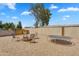 Backyard with fire pit and trampoline in low maintenance desert landscape at 633 S 96Th St, Mesa, AZ 85208