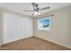 Bedroom features carpet, ceiling fan, and large closet at 633 S 96Th St, Mesa, AZ 85208