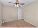 Bedroom with neutral carpet, ceiling fan and adjacent doorway at 633 S 96Th St, Mesa, AZ 85208