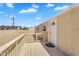 This backyard features a wooden deck and railing, plus a back door leading into the home at 633 S 96Th St, Mesa, AZ 85208