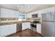 A modern kitchen with stainless steel appliances, white cabinets, and beautiful granite countertops at 633 S 96Th St, Mesa, AZ 85208
