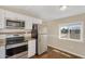 Well-lit kitchen with stainless steel appliances, granite countertops and white cabinets at 633 S 96Th St, Mesa, AZ 85208