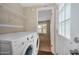 Laundry room featuring newer model washer and dryer with wire shelving above at 633 S 96Th St, Mesa, AZ 85208