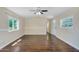 A spacious living room with hardwood floors and ample natural light from multiple windows at 633 S 96Th St, Mesa, AZ 85208