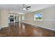 An open-concept living area flows into the kitchen with hardwood flooring and modern recessed lighting at 633 S 96Th St, Mesa, AZ 85208