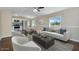 Bright living room featuring modern furniture, wood flooring, and a view to the kitchen and dining area at 633 S 96Th St, Mesa, AZ 85208