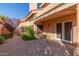 Backyard features a paver patio, plants and bushes, and a view of the home's facade at 6459 E Sugarloaf St, Mesa, AZ 85215