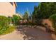 Backyard shows desert landscaping, a low privacy wall, and paver patio at 6459 E Sugarloaf St, Mesa, AZ 85215