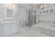 Bright bathroom featuring a walk-in shower, soaking tub, and white marble countertops at 6459 E Sugarloaf St, Mesa, AZ 85215
