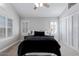 Bedroom featuring a ceiling fan, large windows and a cozy bed at 6459 E Sugarloaf St, Mesa, AZ 85215