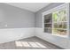 Bright bedroom featuring new gray paint, wood-look flooring, and large window at 6459 E Sugarloaf St, Mesa, AZ 85215