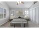 Brightly lit bedroom featuring a ceiling fan, large windows and a cozy bed at 6459 E Sugarloaf St, Mesa, AZ 85215