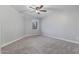 Cozy bedroom with neutral carpet, a modern ceiling fan, and a bright window view at 6459 E Sugarloaf St, Mesa, AZ 85215