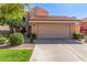 Charming home featuring a two-car garage, a lovely tiled roof, and attractive landscaping with gravel and manicured shrubs at 6459 E Sugarloaf St, Mesa, AZ 85215