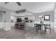 Open kitchen and dining area with white cabinets, gray island, and stainless appliances at 6459 E Sugarloaf St, Mesa, AZ 85215
