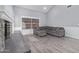 Open-concept living room with a cozy fireplace, neutral colors, and stylish wood flooring, great for entertaining at 6459 E Sugarloaf St, Mesa, AZ 85215