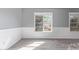 Cozy living room with gray walls, wood-look flooring, and new windows at 6459 E Sugarloaf St, Mesa, AZ 85215