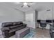 Living room featuring carpet floors, a ceiling fan, a couch, and a desk at 6459 E Sugarloaf St, Mesa, AZ 85215